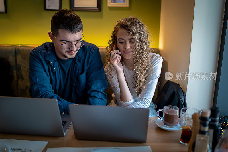 Business people working together at a café using their laptops